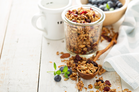 Homemade granola with milk and fresh berries for breakfastの写真素材