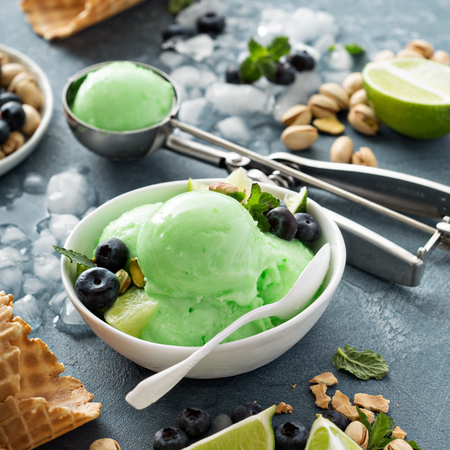 Green refreshing lime pistachio  ice cream in white bowlの写真素材