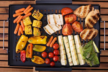 Grilled vegetables, bread and cheese on a grilling pan