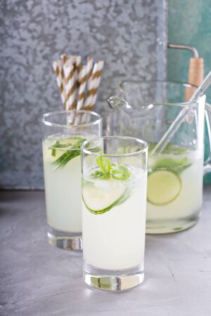 Basil lime and cucumber cooler in pitcher and tall glassesの写真素材