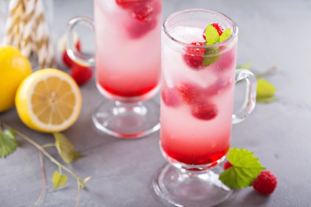 Pink refreshing cold raspberry lemonade in tall glassesの写真素材