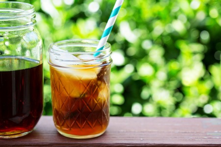 Iced coffee in mason jars outdoors on the front porchの写真素材