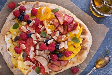 Grilled fruit pizza with cream cheese, honey and coconut best summer dessertの写真素材