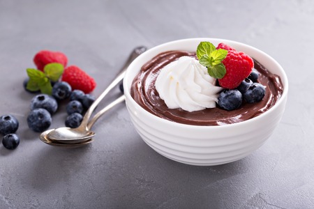 Chocolate pudding with whipped cream and fresh berriesの写真素材
