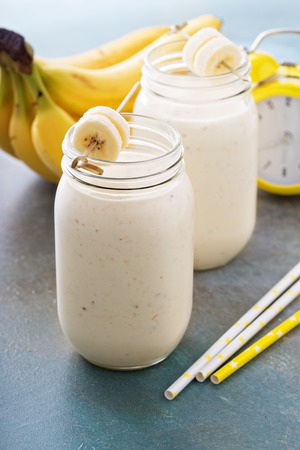 Banana smoothie in mason jars for healthy breakfastの写真素材