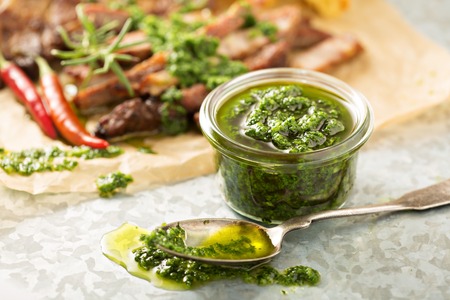 Green chimichurri parsley sauce with grilled steakの写真素材