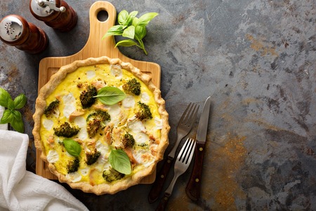 Healthy vegetable and salmon quiche with broccoli and basilの写真素材
