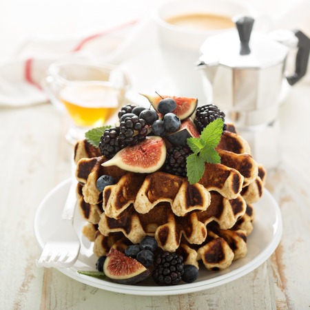 Fluffy breakfast waffles with fresh fruits and berriesの写真素材
