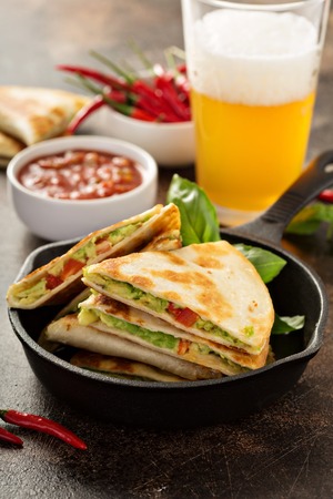 Vegan quesadillas with avocado and red pepper served with tomato salsaの写真素材