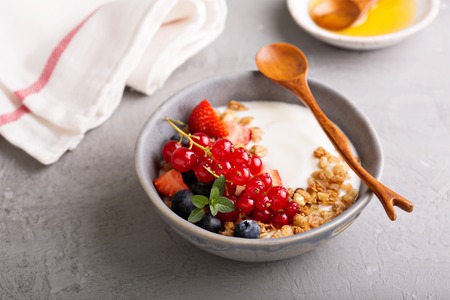 Yogurt bowl with granola and fresh berriesの写真素材