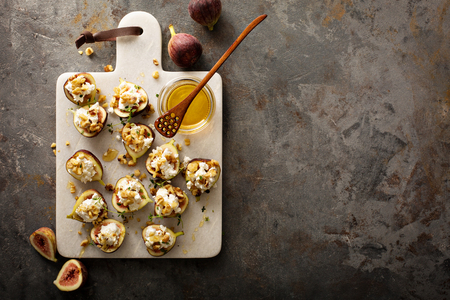 Fall appetizer with figs, feta cheese, honey and walnuts overhead shot with copyspaceの写真素材