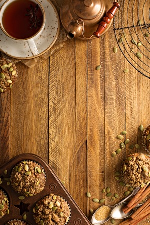 Healthy pumpkin muffins with fall spices and pumpkin seeds fall background overhead shot with copy spaceの写真素材