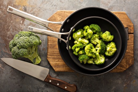 Steamed or stewed broccoli in a skilletの写真素材