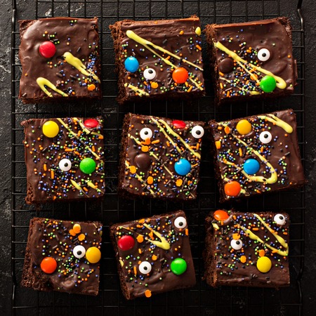 Chocolate monster brownies with candy and sprinkles, homemade treats for Halloween overhead shotの写真素材