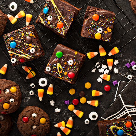 Chocolate monster brownies with candy and sprinkles, homemade treats for Halloween overhead shotの写真素材
