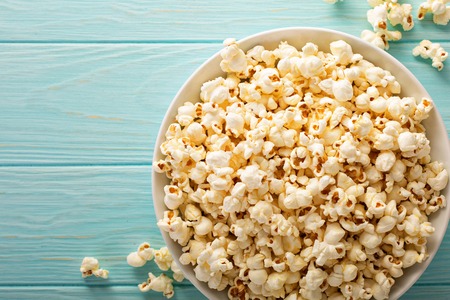 Cheddar cheese popcorn in a white bowlの写真素材