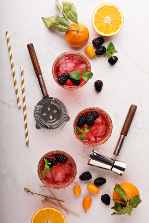 Blackberry citrus margaritas with bartender tools overhead shotの写真素材