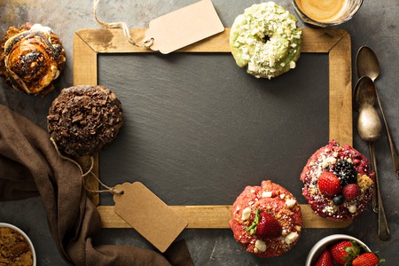 Variety of donuts around a chalkboardの写真素材