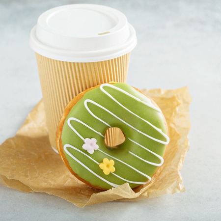 Green matcha glazed donut with cherry