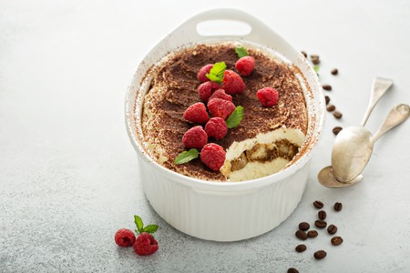 Tiramisu cake in a ceramic dishの写真素材