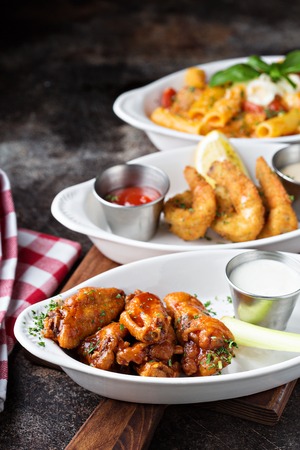 Variety of appetizers with fried shrimp and wingsの写真素材