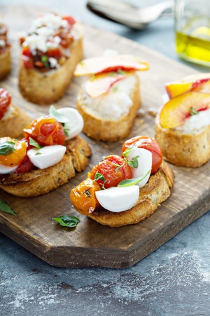 Crostini or bruschetta board with caprese made with roasted tomatoesの写真素材