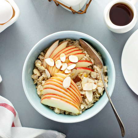 Healthy oatmeal with sliced apple and almondsの写真素材