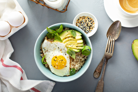 Savory oatmeal with egg and avocadoの写真素材