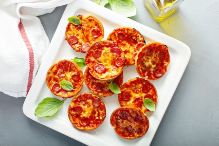 Mini pepperoni pizzas with tomato sauce and mozzarella cheeseの写真素材