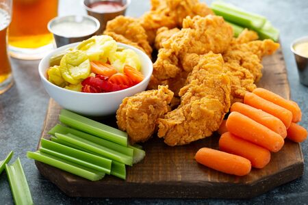 Fried chicken tenders with veggiesの写真素材