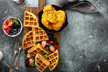 Breakfast platter with waffles, berries and chickenの写真素材