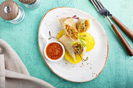 Asian cuisine spring rolls with spicy sauce