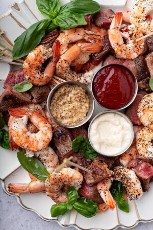 Christmas or New Year party appetizer, shrimp and steakの写真素材