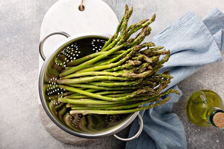 Cooking with asparagus, just washed fresh asparagus in a colanderの写真素材