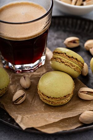 Pistachio macarons with coffee on a tray, french dessertの写真素材