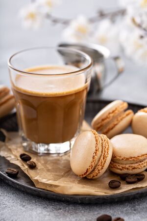 Coffee and cream macarons on a tray, trendy french dessertの写真素材