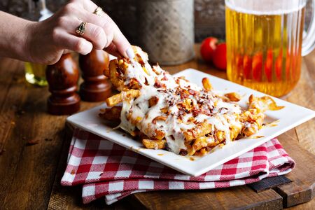 Cheese fries topped with bacon and melted cheese