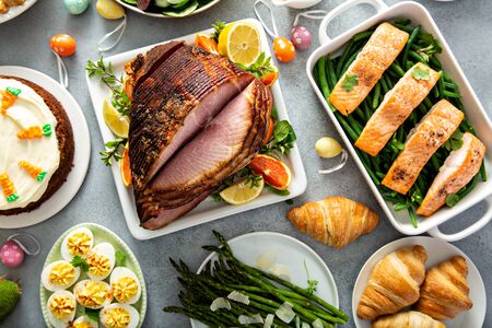 Big traditional Easter brunch with ham, salmon and carrot cake