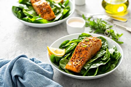 Cedar plank roasted salmon with spinachの写真素材