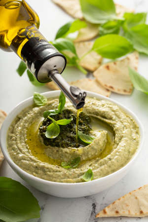 Basil hummus topped with pestoの写真素材