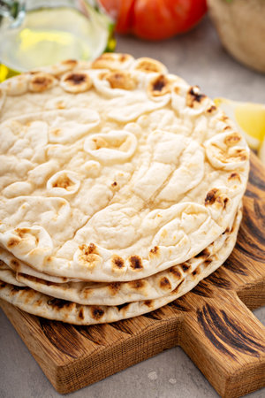 A stack of pita bread on a cutting boardの写真素材