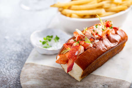 Lobster roll with fries on a marble boardの写真素材