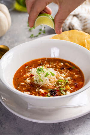 Chili served with crumbled cheese and tortillaの写真素材