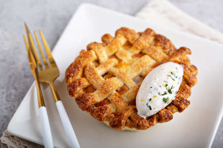 Peach pie topped with lattice and whipped cream