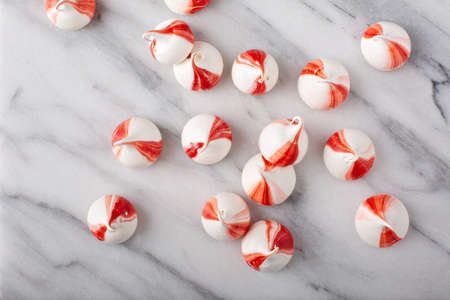 Peppermint meringues on a marble table, Christmas backgroundの写真素材