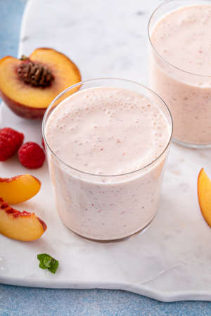 Raspberry peach smoothie, healthy and refreshing drinkの写真素材