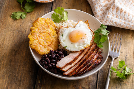 Caribbean or latin american breakfast with rice, beans and porkの写真素材