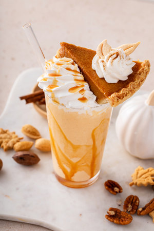 Pumpkin pie milkshake with caramel syrup and whipped creamの写真素材