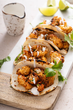 Spicy cauliflower tacos with cilantro and mexican cremaの写真素材