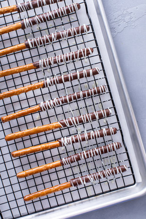 Chocolate covered pretzel rods freshly made on a cooling rackの写真素材